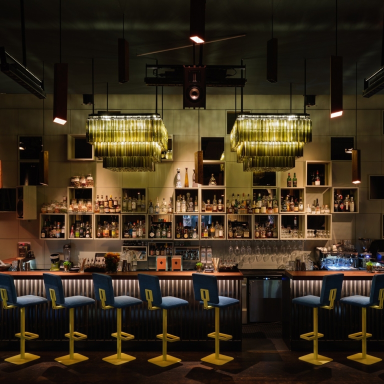 The Crackers bar with bottle shelves and pendant lights