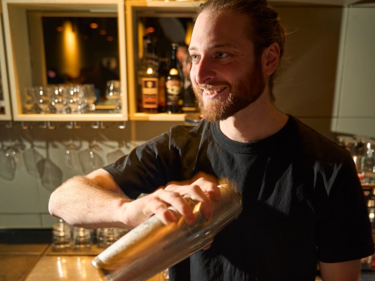 Bartender shaking a cocktail at the Crackers bar